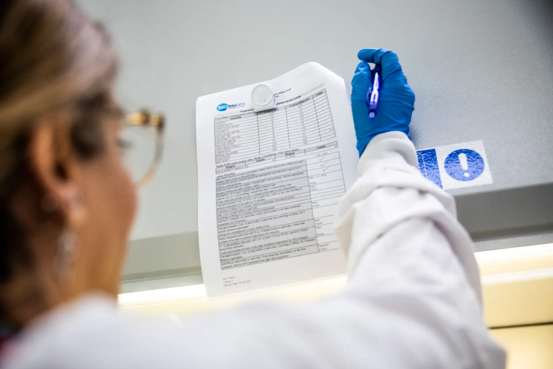 Scientist working in a GCLP, GLP and ISO17035 Laboratory from a QA issued SOP to ensure the reproducibility and quality of data