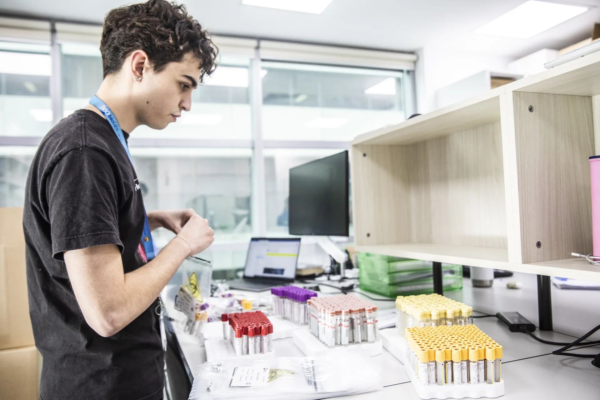 Scientist in our Central Laboratory Services team preparing sample collection kits for a clinical trial